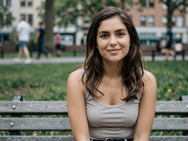 32-year-old woman sitting on a New York park bench, representing New York truck driver dating connections